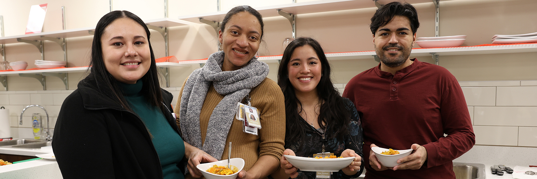 Four people present their dishes in the teaching kitchen
