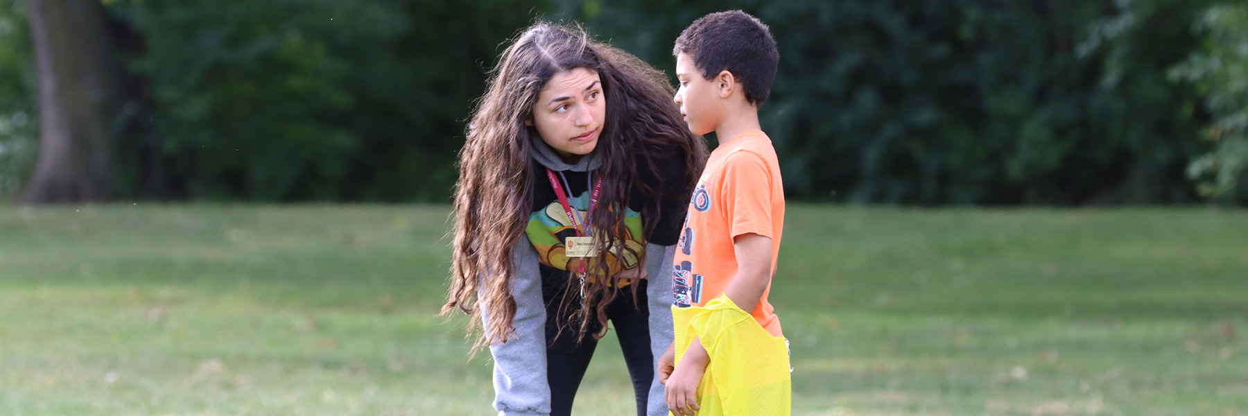 A female student coaching a young boy