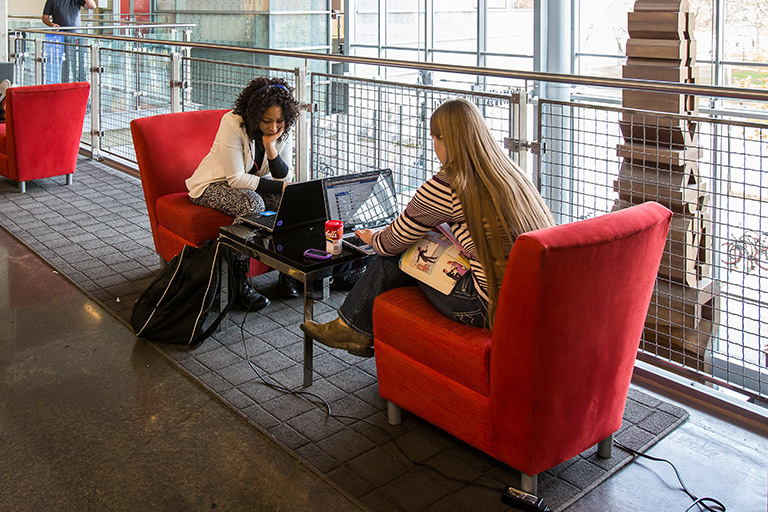 Students complete assignments in student space at the campus center